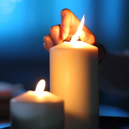 Candle being lit in dark room